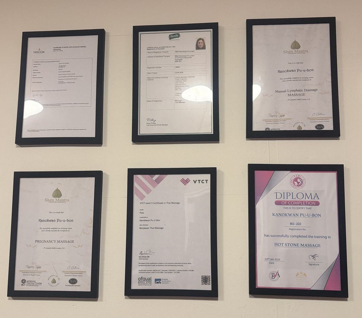 Six framed massage certificates awarded to Kanokwan Pu-u-bon, including Thai, hot stone, pregnancy and lymphatic drainage massage